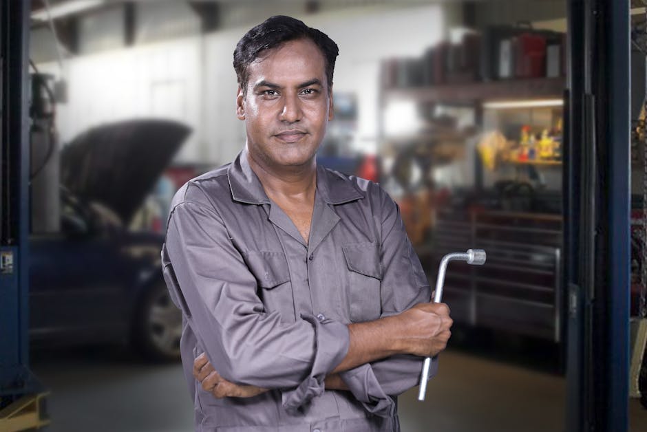 Smiling auto mechanic ready to assist with tire service
