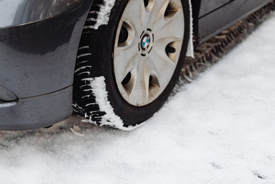 Technician checking tire tread depth for safety